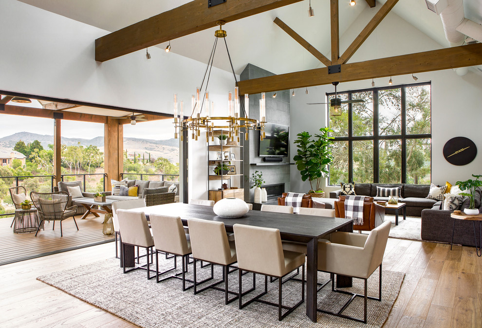 Photo of a large transitional open plan dining in Orange County with white walls, light hardwood floors, no fireplace and brown floor.
