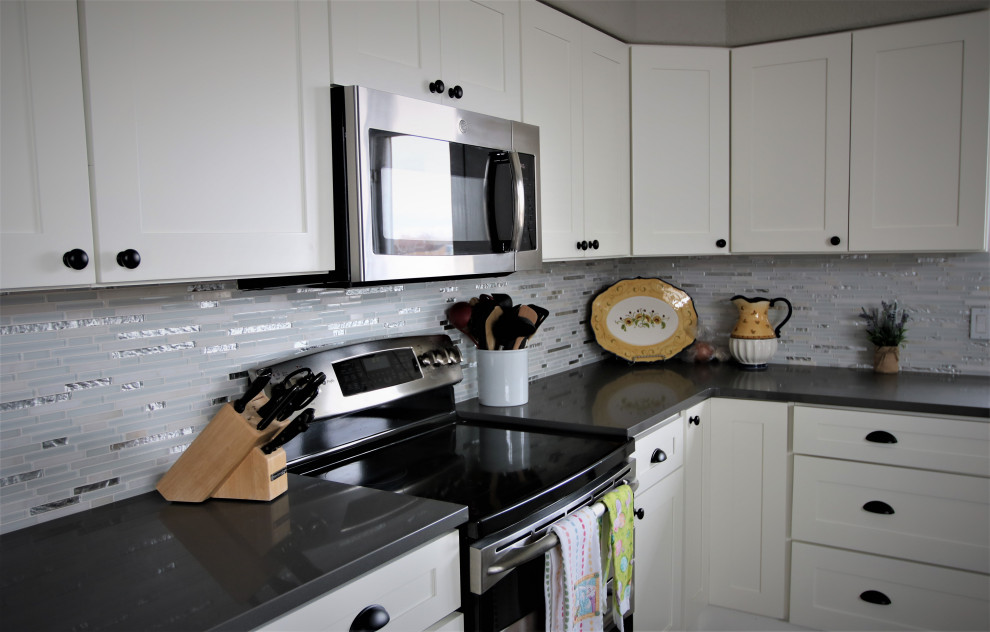 Large transitional u-shaped kitchen photo with shaker cabinets, white cabinets, granite countertops, mosaic tile backsplash, gray countertops and a farmhouse sink