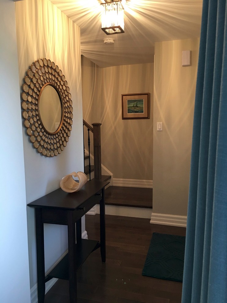Inspiration for a small transitional dark wood floor foyer remodel in Toronto with gray walls