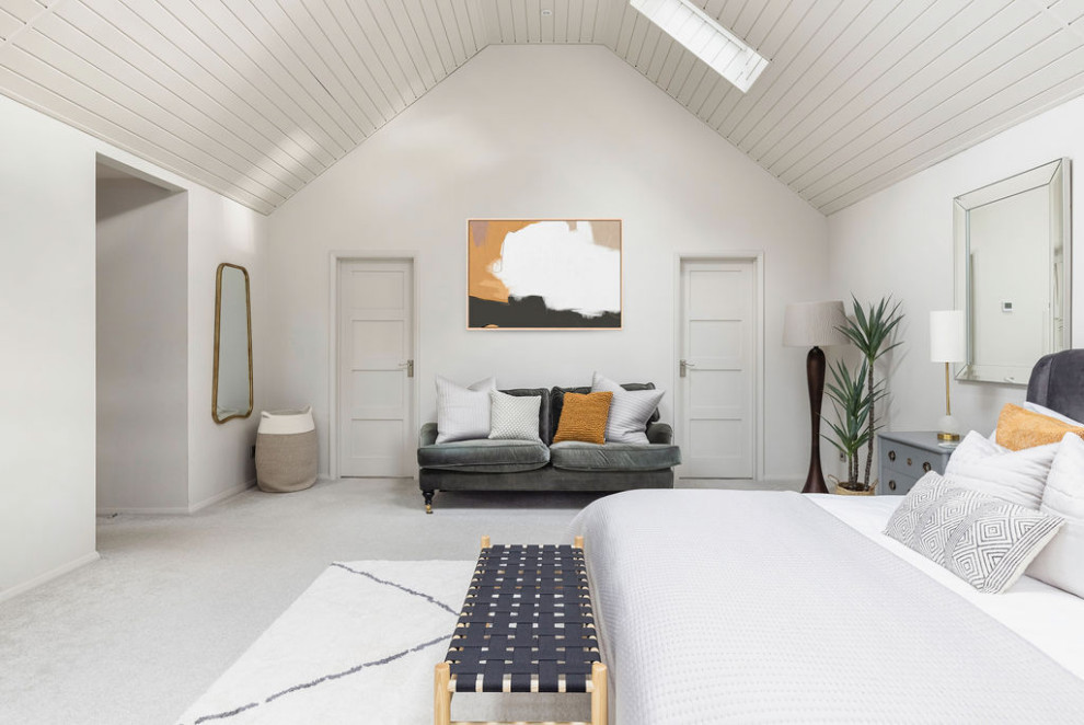 Großes Maritimes Hauptschlafzimmer mit weißer Wandfarbe, Teppichboden, grauem Boden und gewölbter Decke in Surrey