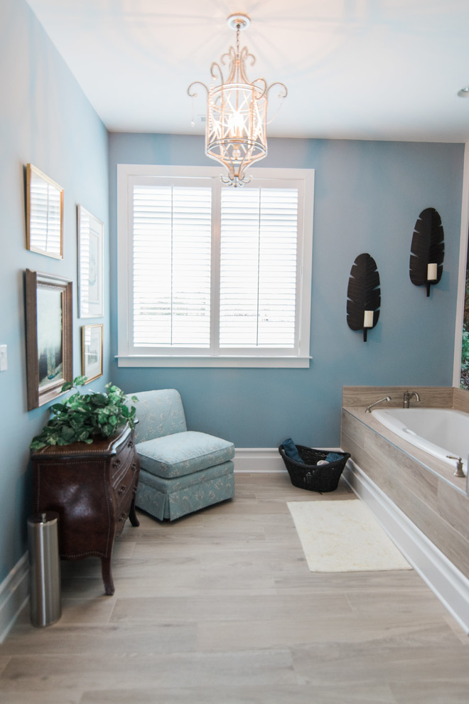 Mid-sized transitional 3/4 bathroom in Baltimore with recessed-panel cabinets, dark wood cabinets, a drop-in tub, an alcove shower, beige tile, beige walls, pebble tile floors, marble benchtops, beige floor and an open shower.