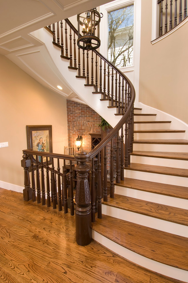 Inspiration for a traditional wood curved staircase in Houston with painted wood risers.