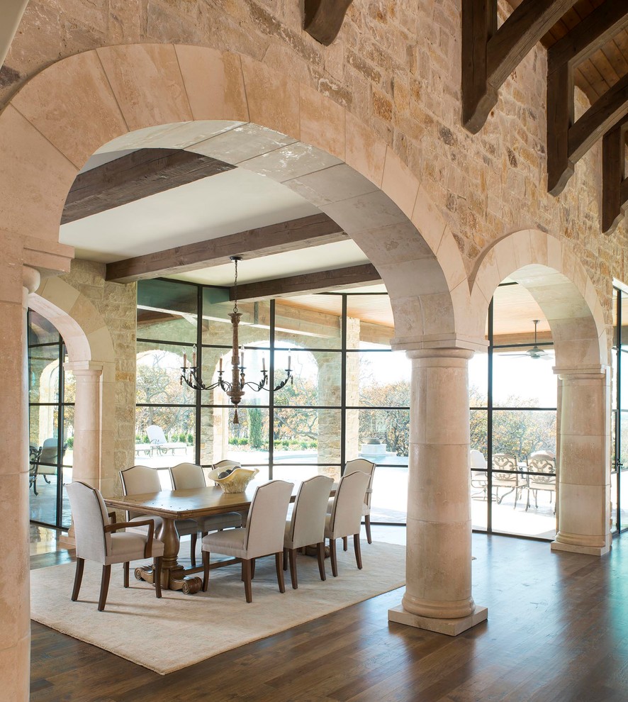 Photo of an expansive mediterranean dining room in Dallas with multi-coloured walls, light hardwood floors and no fireplace.