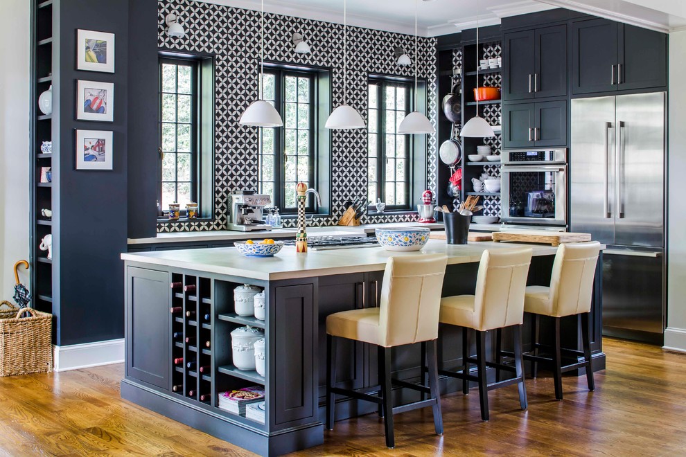 Inspiration for a transitional l-shaped kitchen in Atlanta with shaker cabinets, black cabinets, multi-coloured splashback, stainless steel appliances, with island, brown floor, white benchtop and dark hardwood floors.