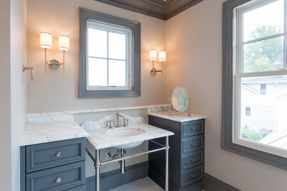 Design ideas for a country master bathroom in DC Metro with recessed-panel cabinets, grey cabinets, a freestanding tub, marble benchtops, grey benchtops, a double shower, a two-piece toilet, gray tile, marble, white walls, marble floors, a pedestal sink, grey floor and a hinged shower door.