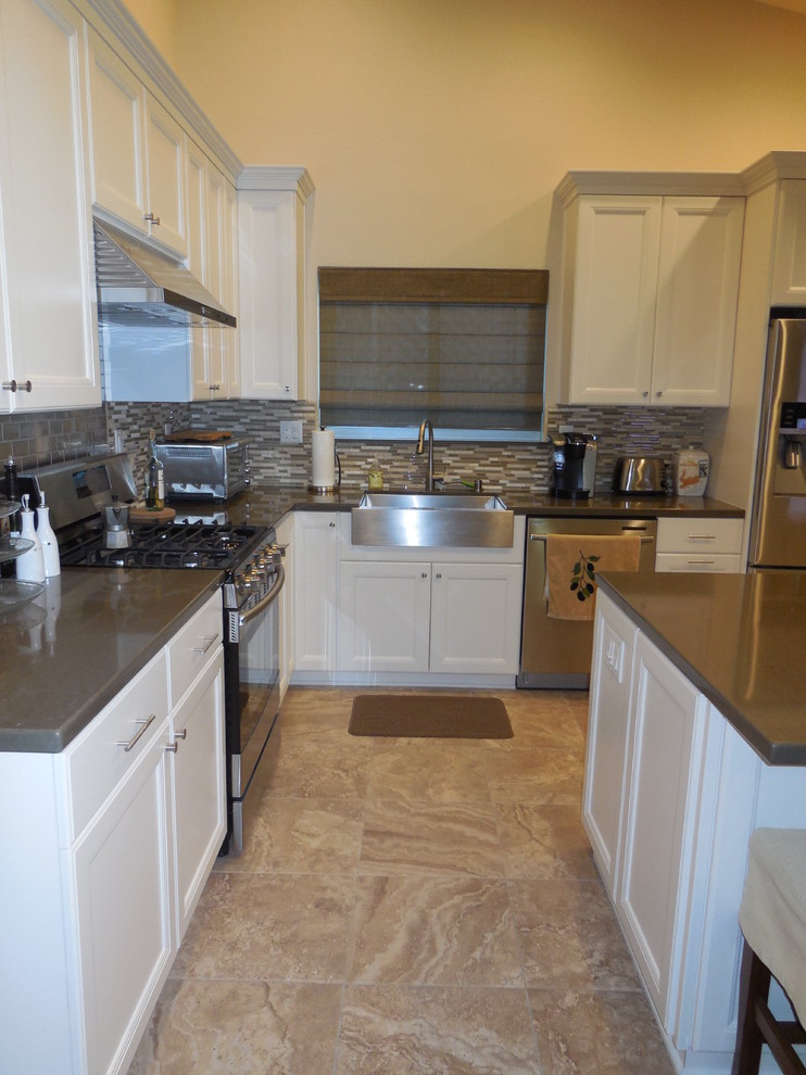 This is an example of a traditional l-shaped eat-in kitchen in Sacramento with a farmhouse sink, flat-panel cabinets, white cabinets, quartzite benchtops, green splashback, mosaic tile splashback, stainless steel appliances and with island.