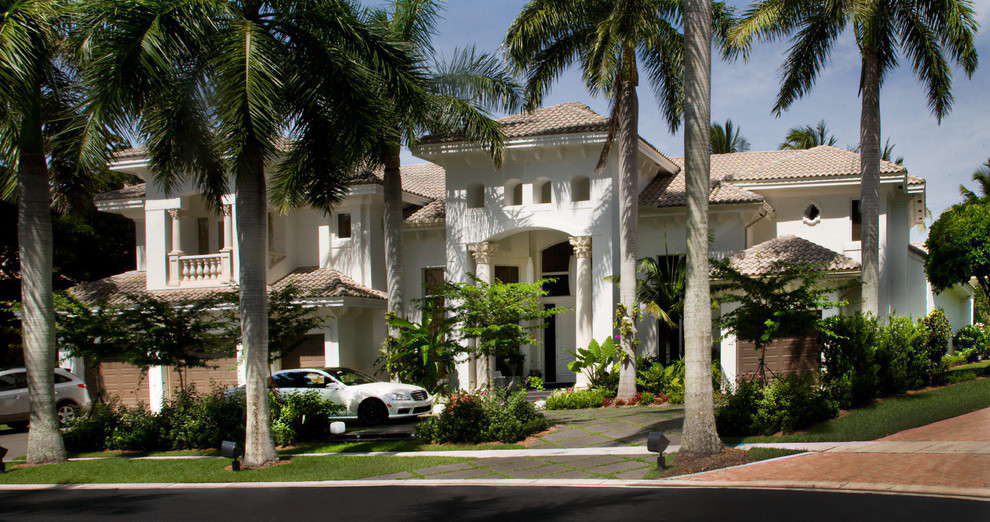 Inspiration for an expansive mediterranean two-storey stucco beige exterior in Miami.