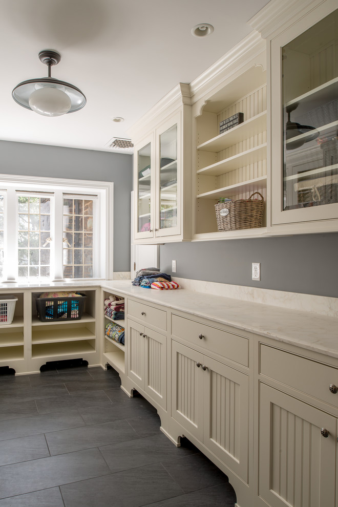 Inspiration for a traditional galley dedicated laundry room in Philadelphia with white cabinets, granite benchtops, grey walls, slate floors and beaded inset cabinets.
