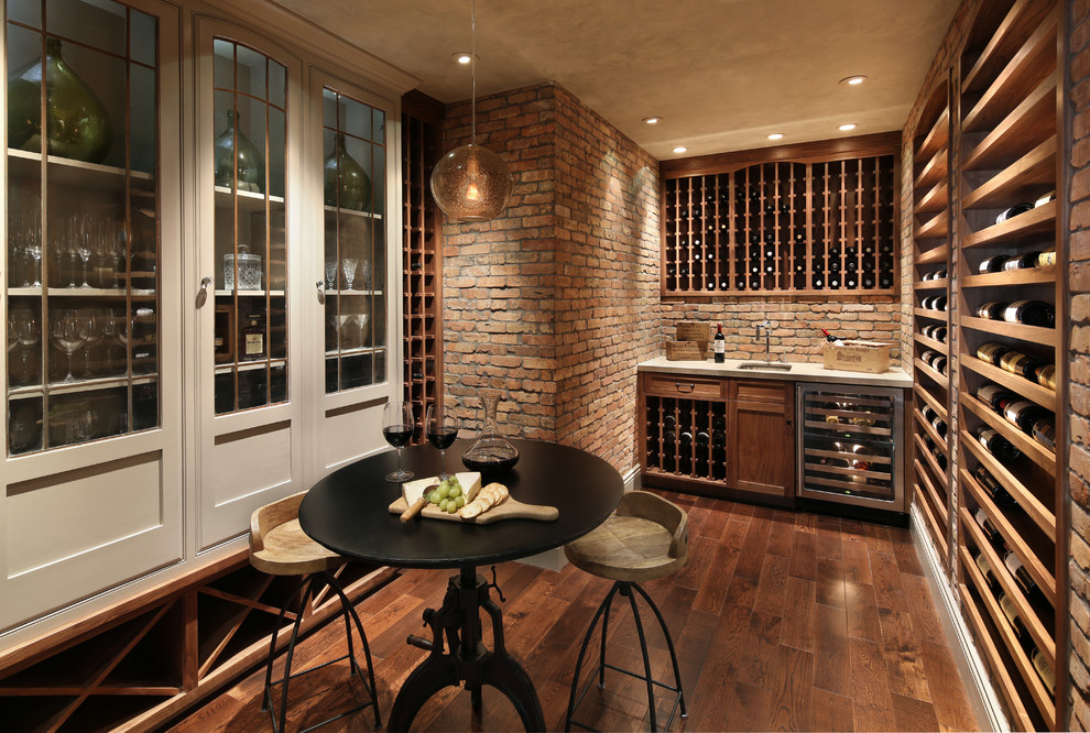 Mid-sized country wine cellar in San Francisco with dark hardwood floors and display racks.