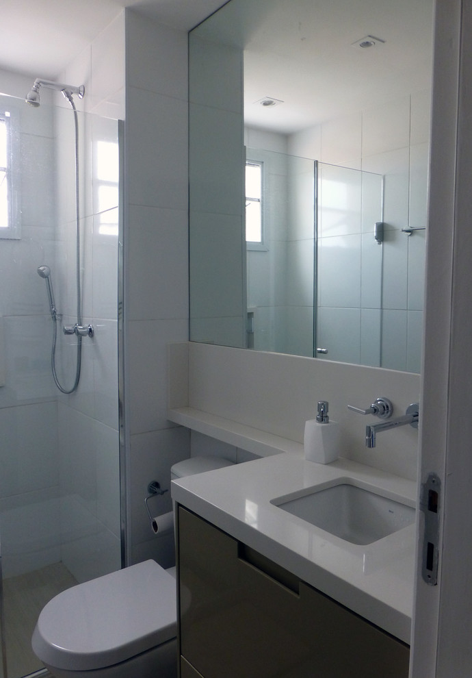 This is an example of a small contemporary bathroom in Other with flat-panel cabinets, beige cabinets, a one-piece toilet, white tile, porcelain tile, porcelain floors and solid surface benchtops.