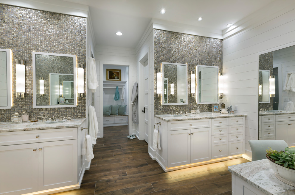Design ideas for a large beach style master bathroom in Charleston with shaker cabinets, white cabinets, mosaic tile, white walls, brown floor, porcelain floors, an undermount sink, marble benchtops and beige benchtops.