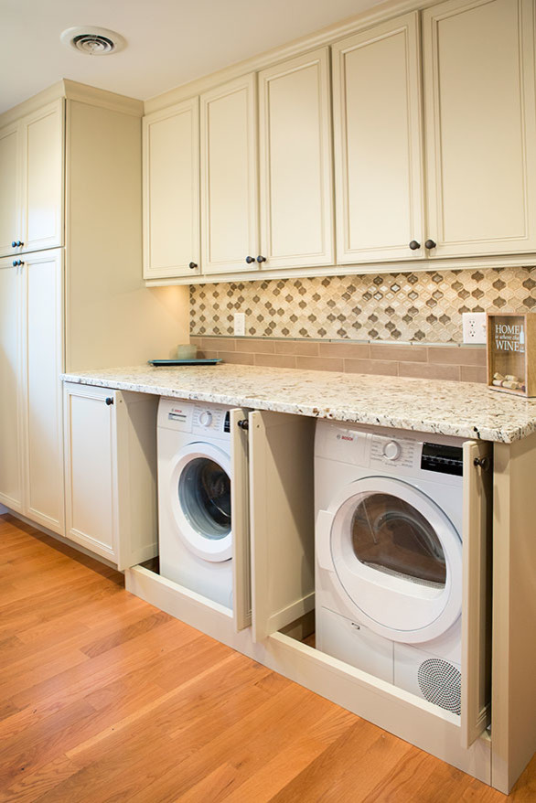 Inspiration for a large transitional single-wall laundry room in St Louis with an undermount sink, beaded inset cabinets, white cabinets, granite benchtops, multi-coloured splashback and medium hardwood floors.