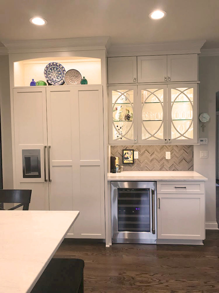 Inspiration for a transitional kitchen remodel with flat-panel cabinets, white cabinets, quartz countertops, gray backsplash and white countertops