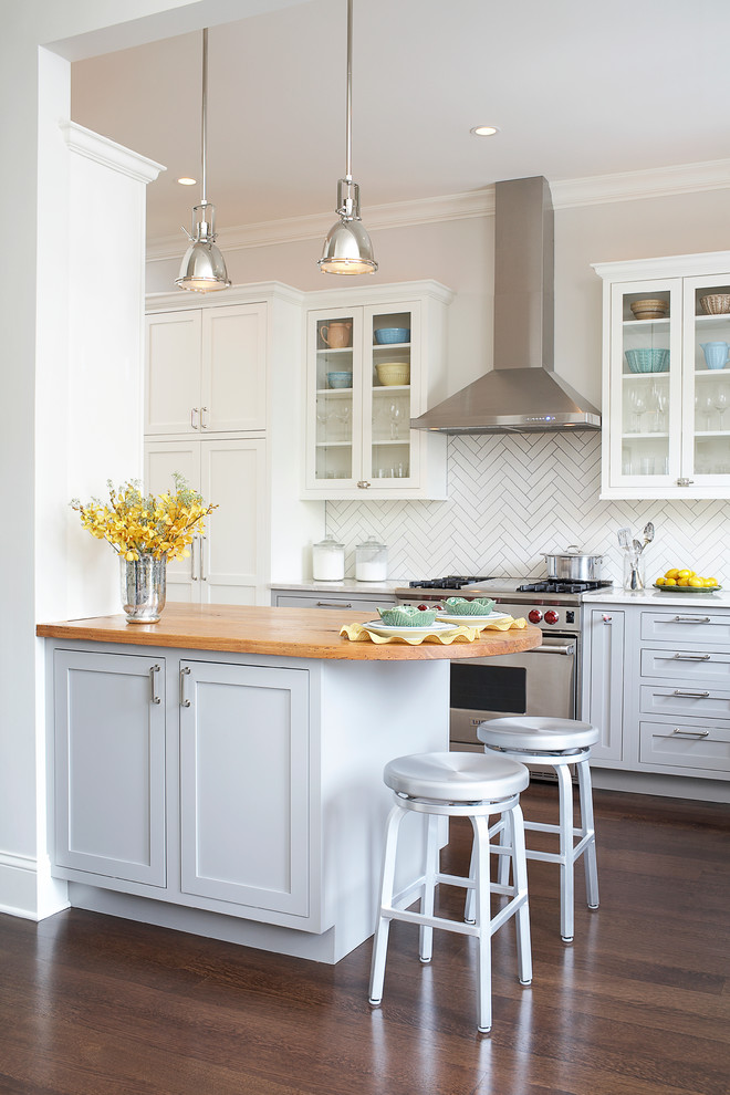Inspiration for a traditional kitchen in Chicago with white cabinets, wood benchtops, white splashback and shaker cabinets.