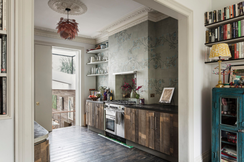 Design ideas for an eclectic galley separate kitchen in London with flat-panel cabinets, medium wood cabinets, grey splashback, white appliances, dark hardwood floors, brown floor and black benchtop.