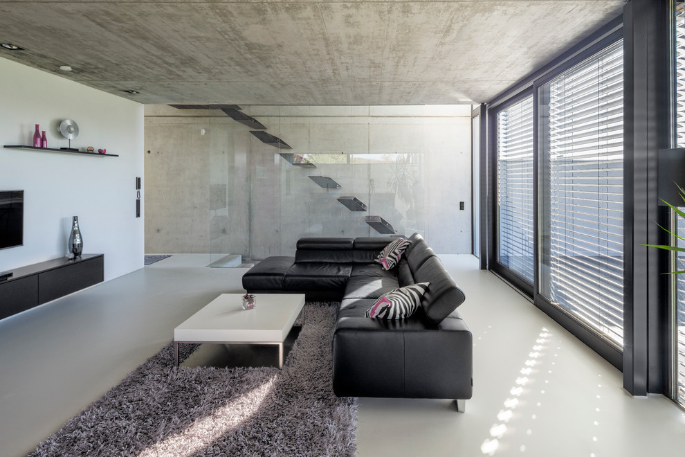 Large contemporary formal open concept living room in Stuttgart with a wall-mounted tv and white walls.