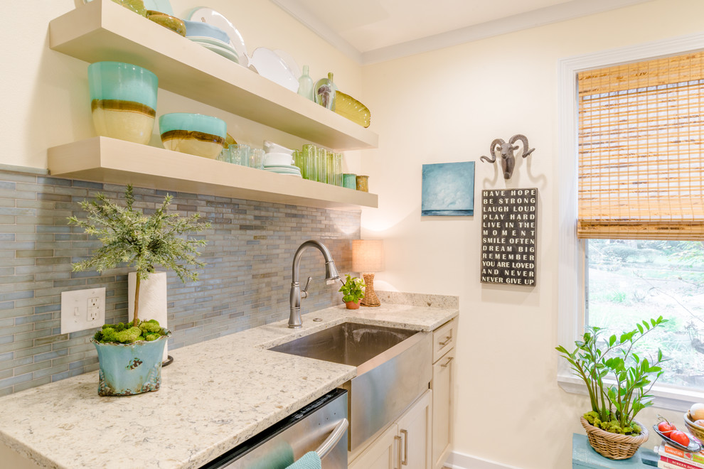 Inspiration for a small transitional galley separate kitchen in Miami with a farmhouse sink, shaker cabinets, beige cabinets, quartz benchtops, blue splashback, glass tile splashback, stainless steel appliances, porcelain floors and no island.