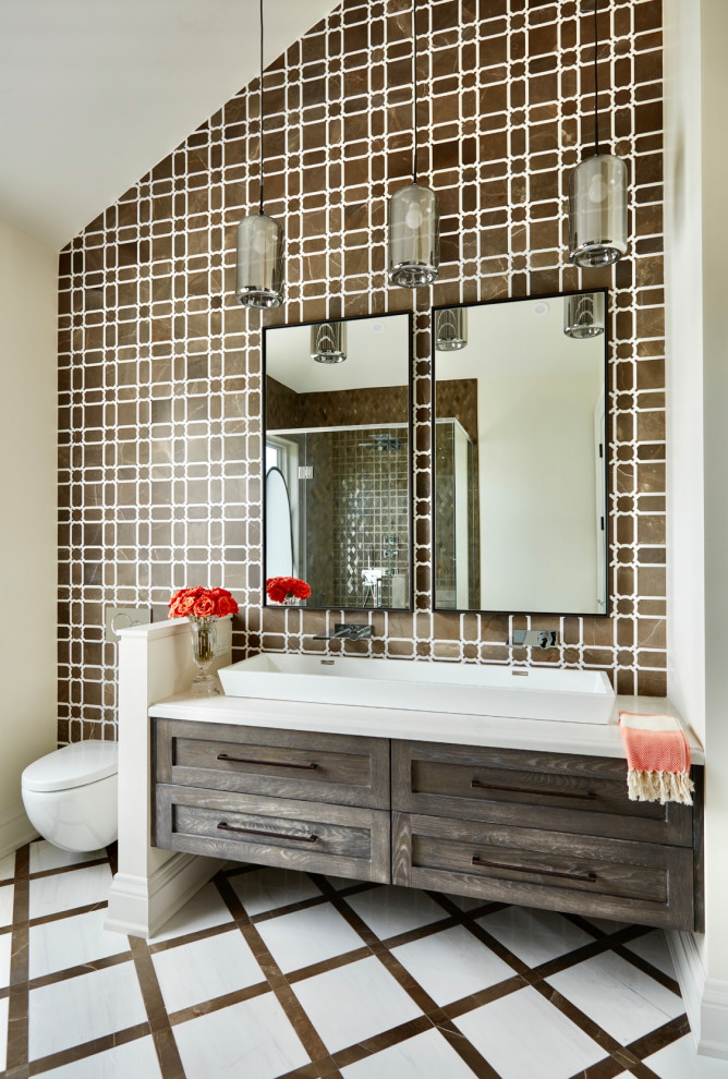 This is an example of a large master bathroom in Toronto with brown cabinets, an alcove shower, a wall-mount toilet, brown tile, marble, brown walls, marble floors, a vessel sink, marble benchtops, multi-coloured floor, a hinged shower door, white benchtops, a double vanity, a floating vanity and shaker cabinets.
