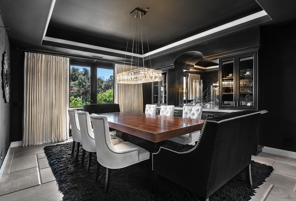Photo of a contemporary dining room in Orange County with black walls.