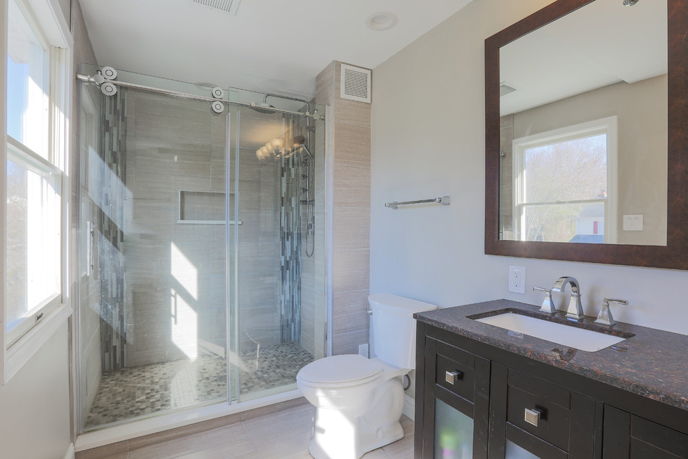 Mid-sized transitional master porcelain tile and beige floor alcove shower photo in Baltimore with furniture-like cabinets, dark wood cabinets, a two-piece toilet, beige walls, an undermount sink and granite countertops