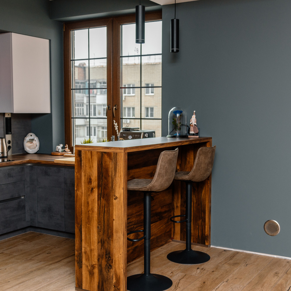Mid-sized industrial u-shaped eat-in kitchen in Other with flat-panel cabinets, grey cabinets, grey splashback and a peninsula.
