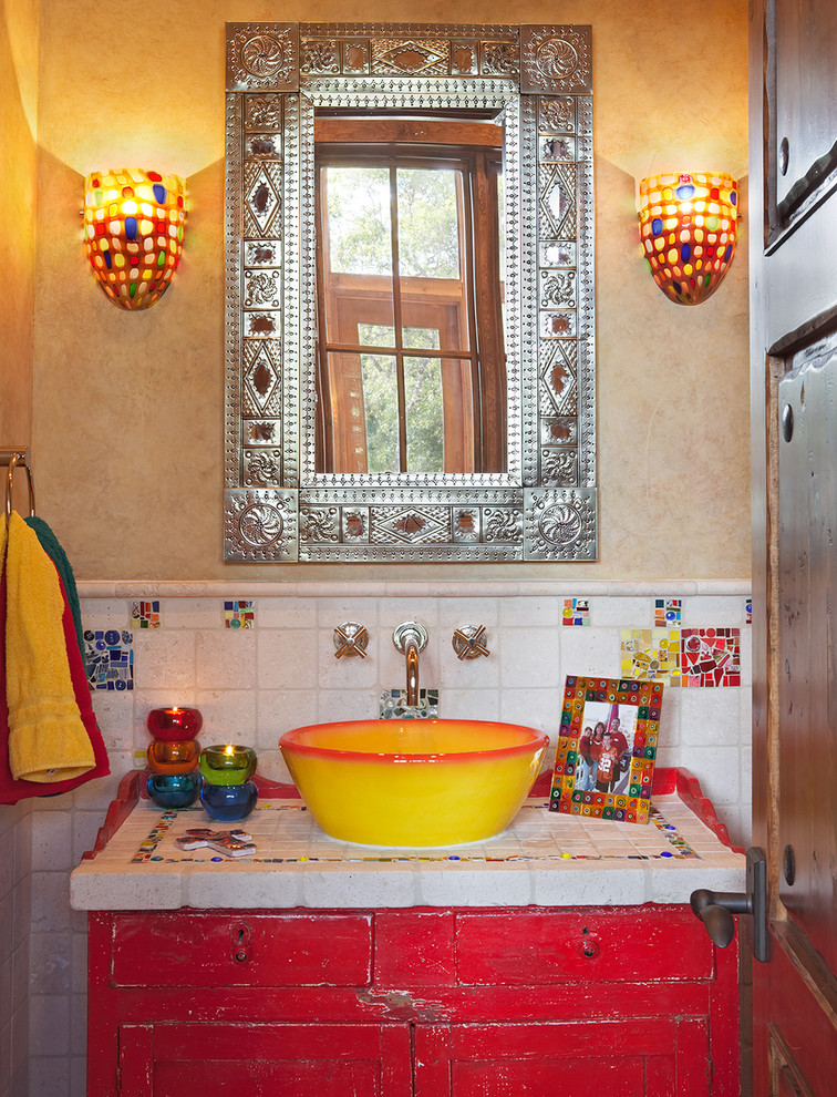 Inspiration for a powder room in Austin with a vessel sink, tile benchtops, red cabinets, ceramic tile, beige walls, recessed-panel cabinets and white benchtops.