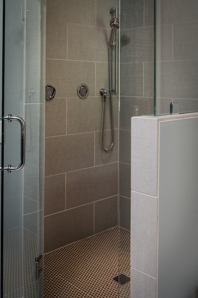 Inspiration for a large transitional master gray tile and ceramic tile ceramic tile freestanding bathtub remodel with flat-panel cabinets, gray cabinets, a two-piece toilet, gray walls, an undermount sink and granite countertops
