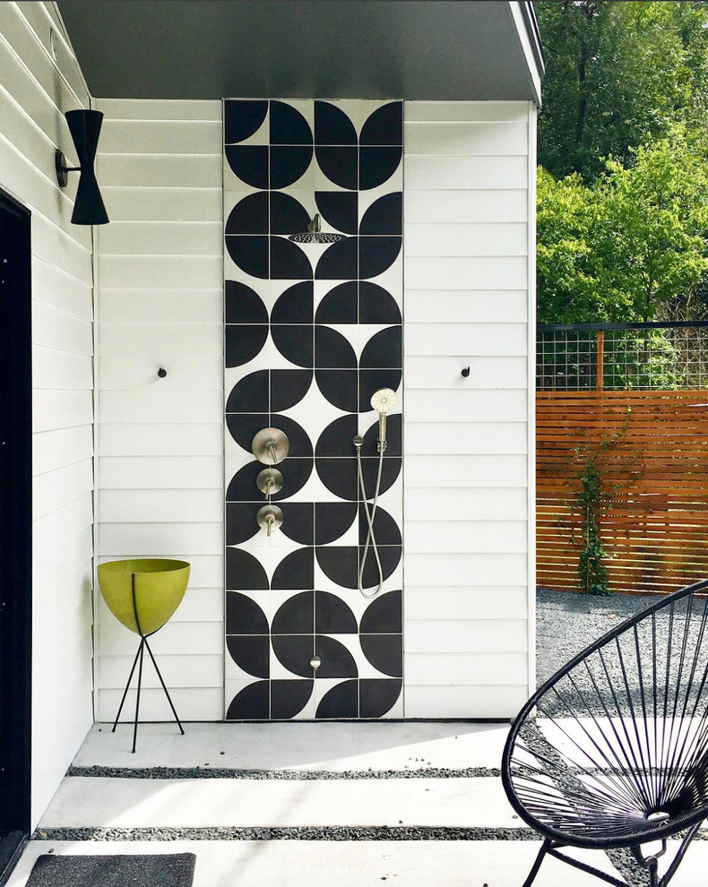 Design ideas for a midcentury backyard patio with an outdoor shower and a roof extension.
