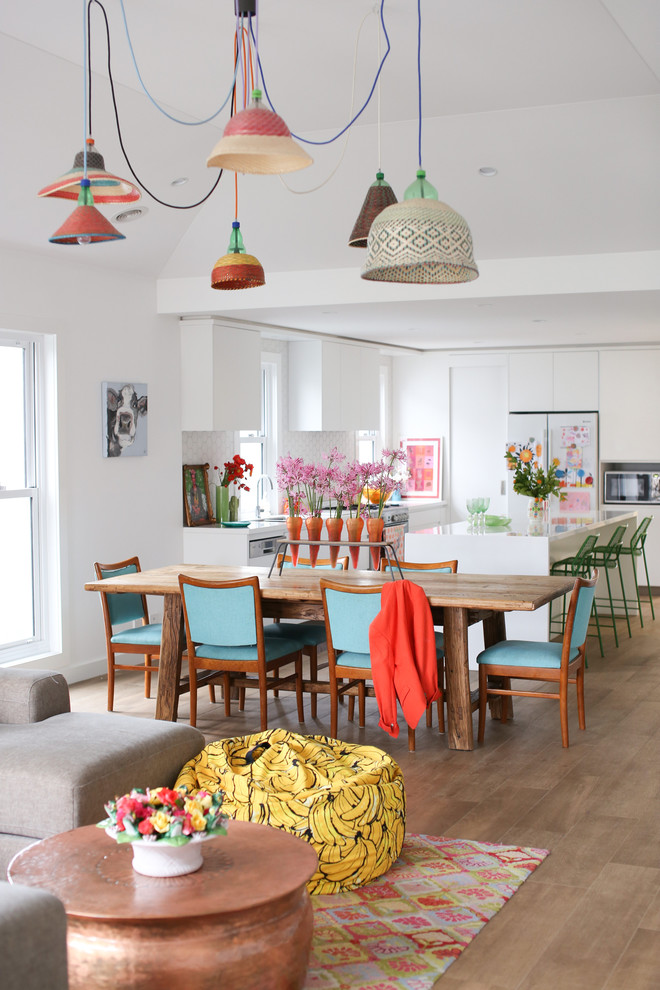Design ideas for an eclectic open plan dining in Sydney with white walls and light hardwood floors.