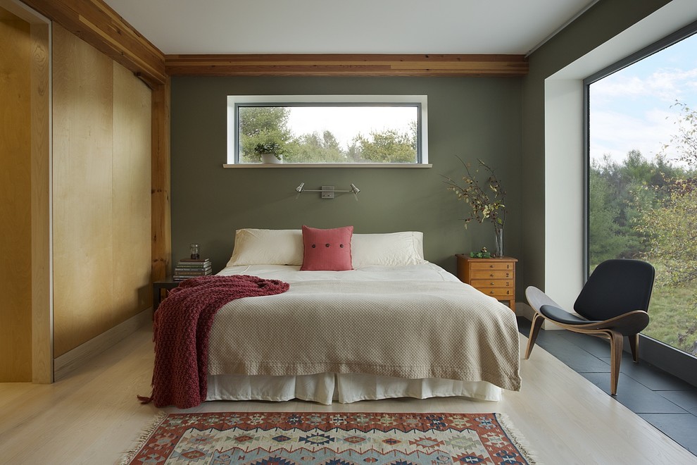 Design ideas for a mid-sized country master bedroom in Boston with green walls and light hardwood floors.