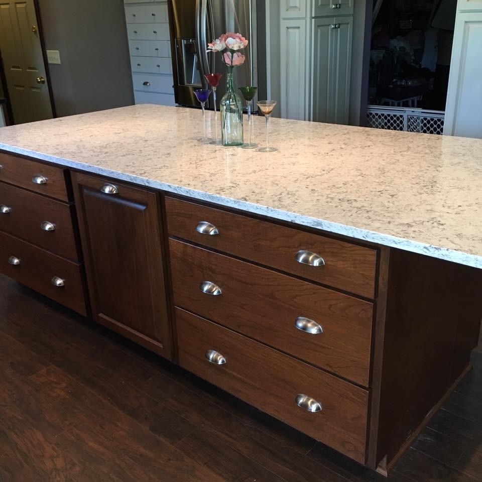 Inspiration for a mid-sized rustic u-shaped dark wood floor eat-in kitchen remodel with an undermount sink, raised-panel cabinets, dark wood cabinets, granite countertops, stainless steel appliances and an island
