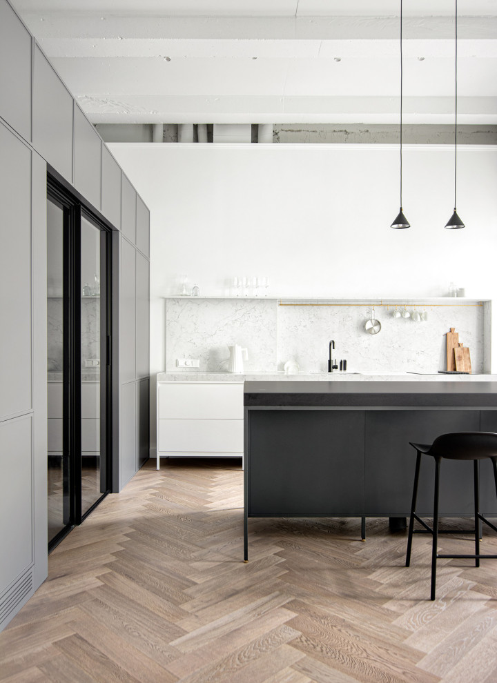 Contemporary kitchen in Moscow with white cabinets and light hardwood flooring.
