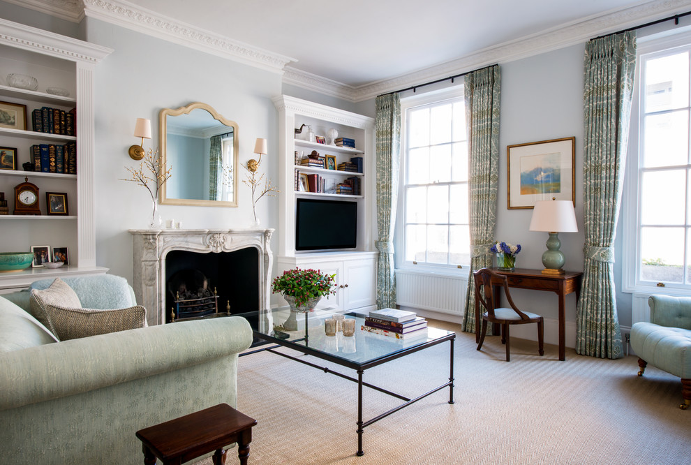 Design ideas for a mid-sized transitional formal enclosed living room in London with blue walls, carpet, a standard fireplace, a stone fireplace surround and a wall-mounted tv.