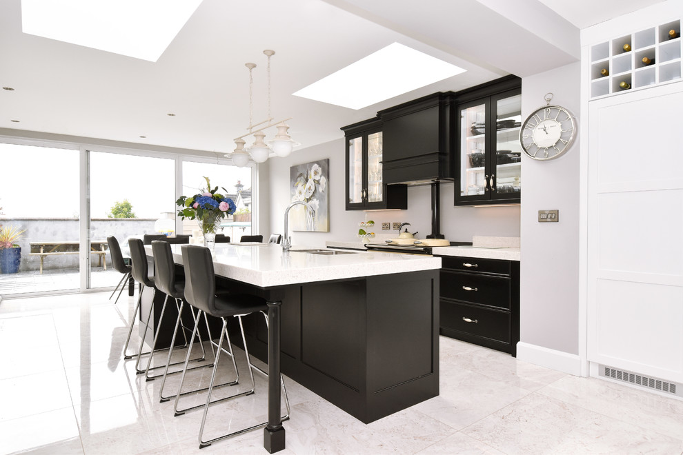 This is an example of a large contemporary single-wall kitchen in Other with recessed-panel cabinets, marble benchtops, white splashback and with island.