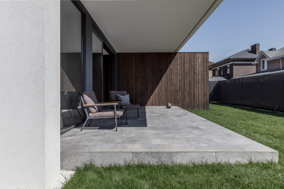Immagine di una terrazza minimal di medie dimensioni, in cortile e a piano terra