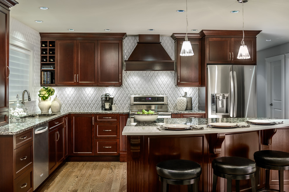 Design ideas for a mid-sized traditional l-shaped separate kitchen in Vancouver with stainless steel appliances, a double-bowl sink, shaker cabinets, dark wood cabinets, granite benchtops, grey splashback, ceramic splashback, light hardwood floors, with island and brown floor.