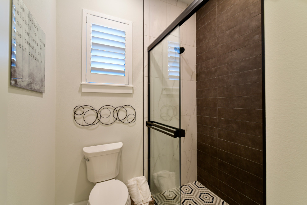 Sliding shower door - mid-sized transitional kids' gray tile and porcelain tile porcelain tile, white floor and double-sink sliding shower door idea with shaker cabinets, black cabinets, a two-piece toilet, gray walls, an undermount sink, quartz countertops, white countertops and a built-in vanity