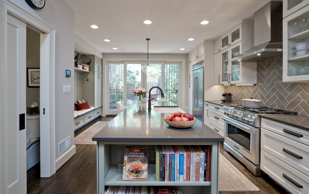 Inspiration for a large contemporary galley eat-in kitchen in DC Metro with a farmhouse sink, shaker cabinets, white cabinets, solid surface benchtops, brown splashback, ceramic splashback, stainless steel appliances, dark hardwood floors, with island, brown floor and brown benchtop.