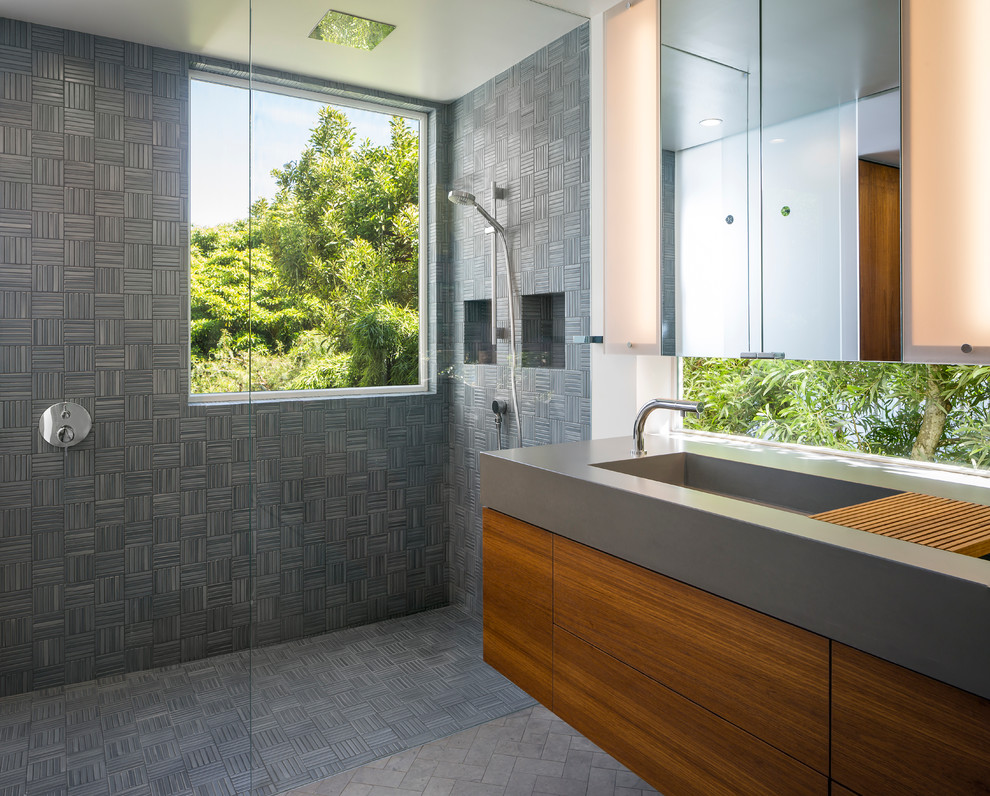 Mid-sized modern master bathroom in San Francisco with an integrated sink, flat-panel cabinets, medium wood cabinets, concrete benchtops, a curbless shower, a wall-mount toilet, gray tile, porcelain tile, white walls and porcelain floors.