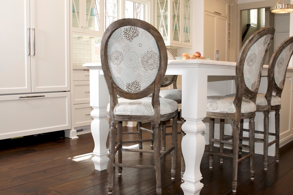 Mid-sized transitional u-shaped dark wood floor eat-in kitchen photo in Atlanta with an undermount sink, glass-front cabinets, white cabinets, quartz countertops, white backsplash, subway tile backsplash, paneled appliances and an island