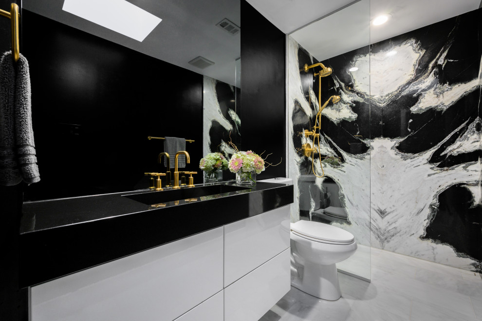 Mid-sized trendy 3/4 marble tile and black and white tile white floor, single-sink and ceramic tile bathroom photo in Dallas with flat-panel cabinets, white cabinets, a two-piece toilet, black walls, a trough sink, marble countertops, black countertops and a floating vanity