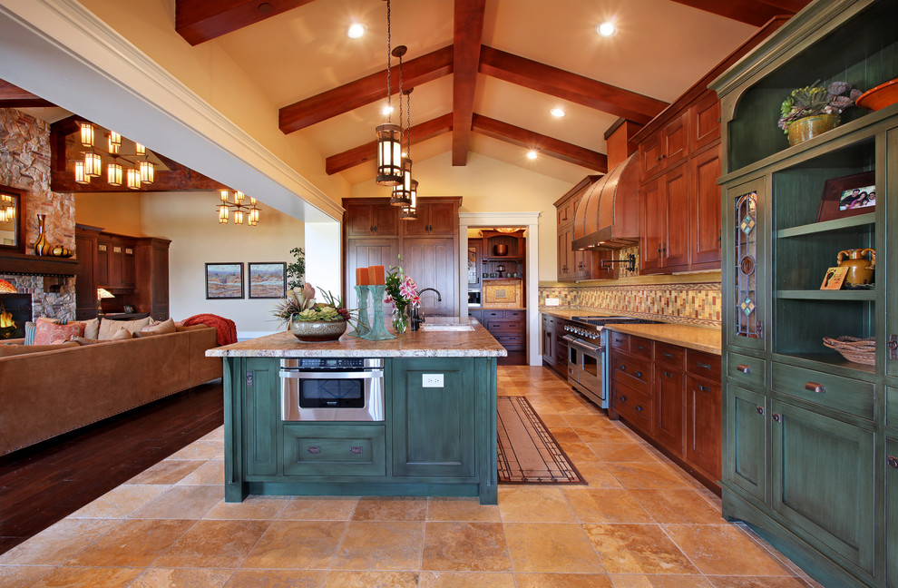 Photo of a large arts and crafts l-shaped open plan kitchen in San Diego with an undermount sink, recessed-panel cabinets, dark wood cabinets, multi-coloured splashback, stainless steel appliances, granite benchtops, ceramic splashback, ceramic floors, with island and multi-coloured floor.