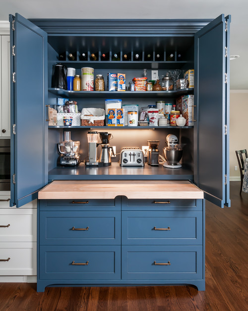Open blue pantry cabinet with wide doors and drawers—even reveals after European hinge adjustments
