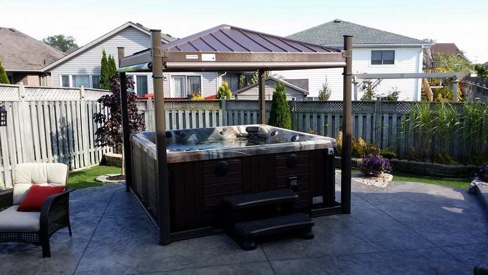 Photo of a large traditional backyard pool in Toronto with a hot tub.