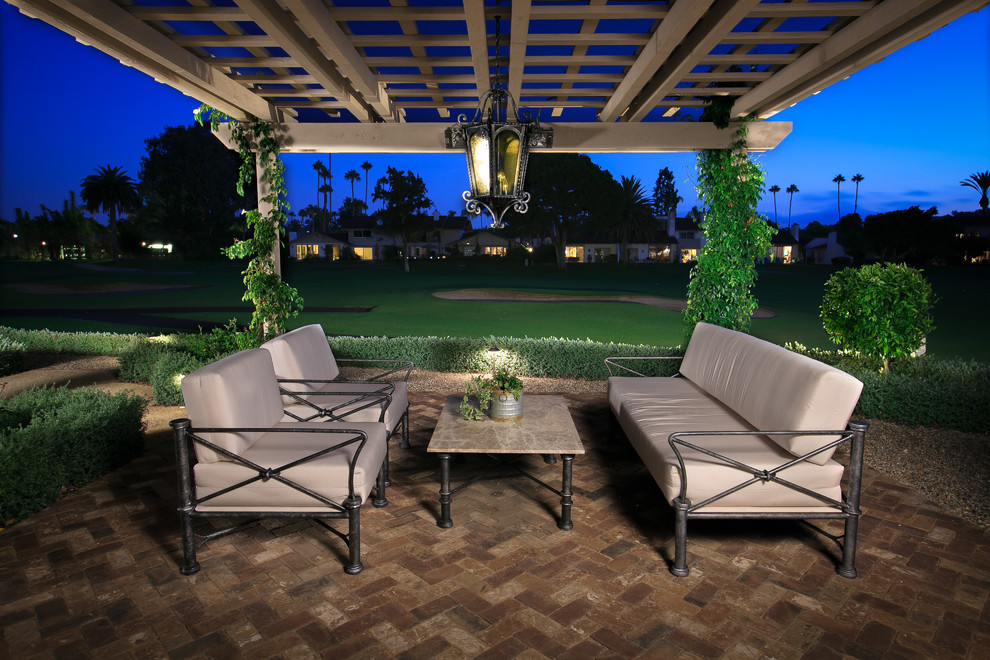 Mid-sized mediterranean backyard patio in San Diego with a fire feature, brick pavers and a pergola.