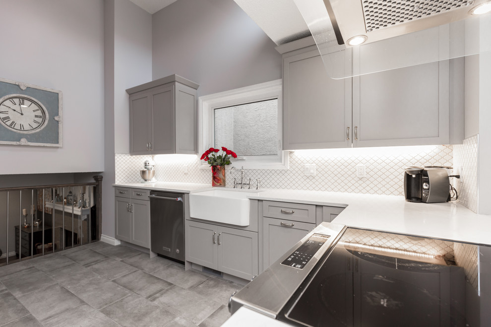 Transitional dark wood floor and brown floor eat-in kitchen photo in Calgary with a farmhouse sink, shaker cabinets, gray cabinets, quartz countertops, white backsplash and stainless steel appliances