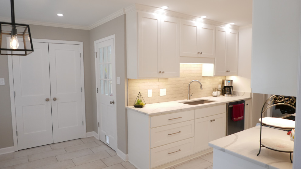 Eat-in kitchen - mid-sized transitional galley porcelain tile and beige floor eat-in kitchen idea with an undermount sink, shaker cabinets, white cabinets, quartz countertops, brown backsplash, porcelain backsplash, stainless steel appliances, no island and white countertops