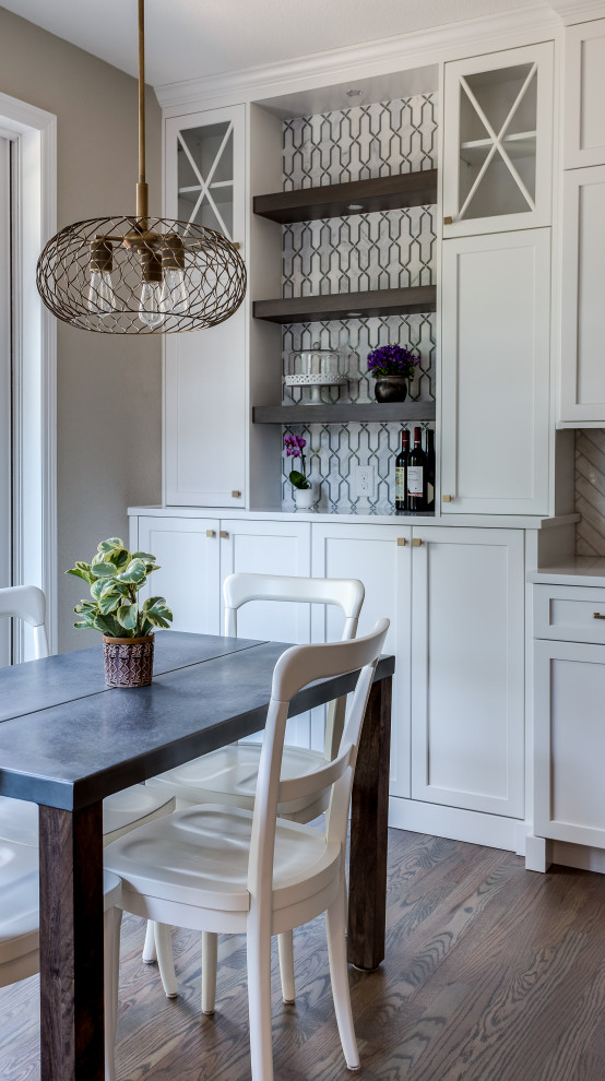 Inspiration for a large transitional galley medium tone wood floor and brown floor open concept kitchen remodel in Denver with an undermount sink, shaker cabinets, white cabinets, quartz countertops, beige backsplash, marble backsplash, stainless steel appliances, an island and white countertops
