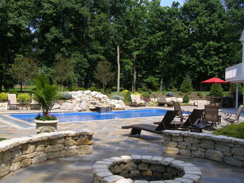 Example of a mountain style backyard stone aboveground pool design in Cincinnati
