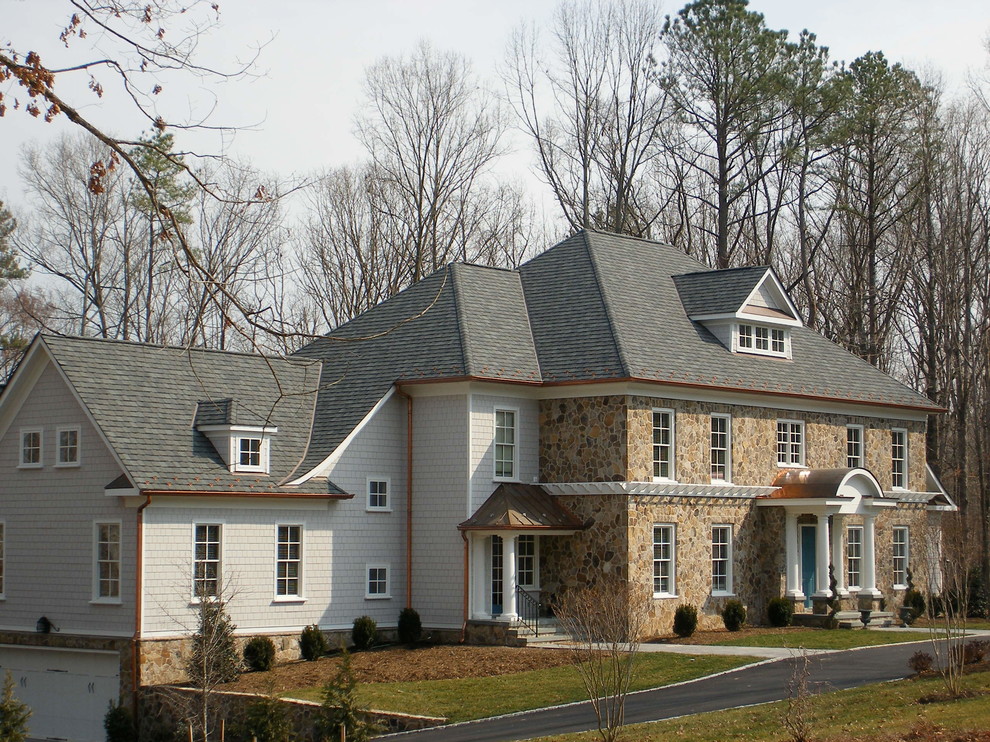 Photo of a large traditional two-storey beige house exterior in Richmond with stone veneer, a hip roof and a shingle roof.